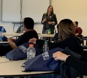 Instructor speaking to students in a classroom