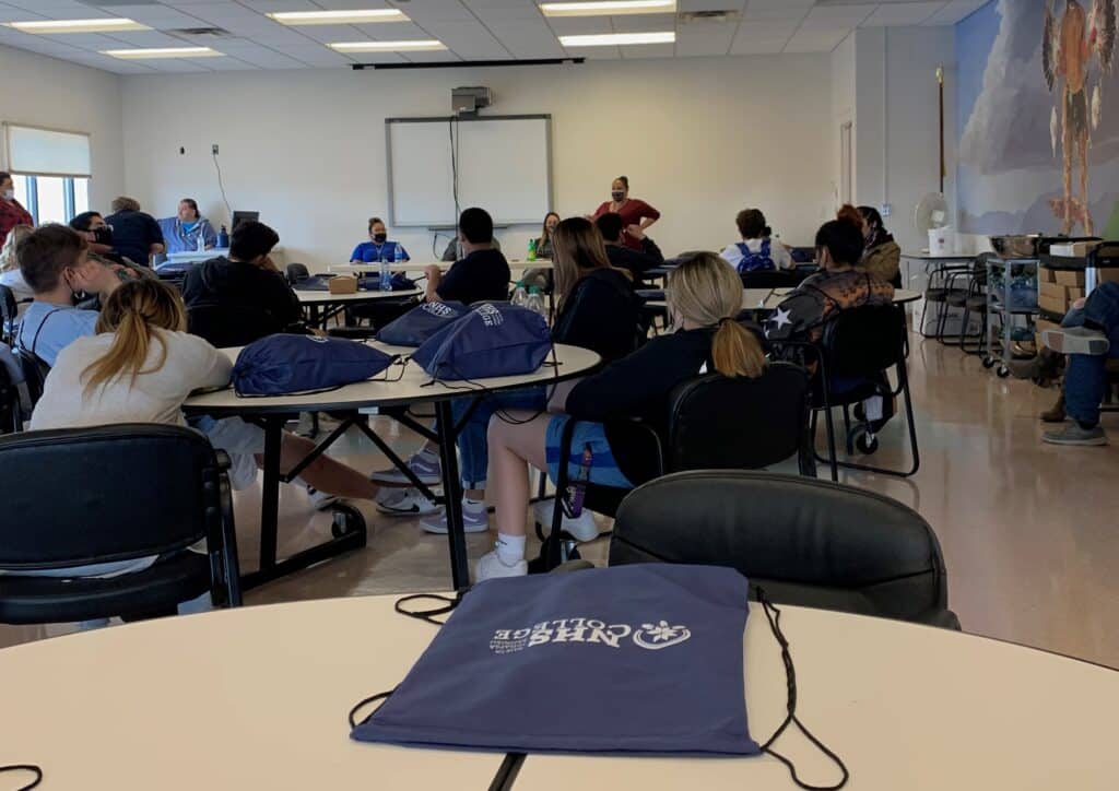 NHSC students in a classroom on round tables