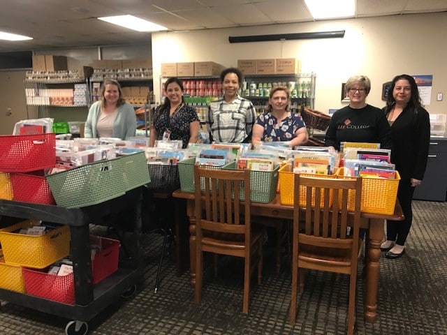 Staff at Lee College assemble book baskets for young children of parents attending college.