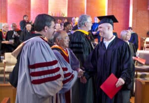 A student receives his diploma. 