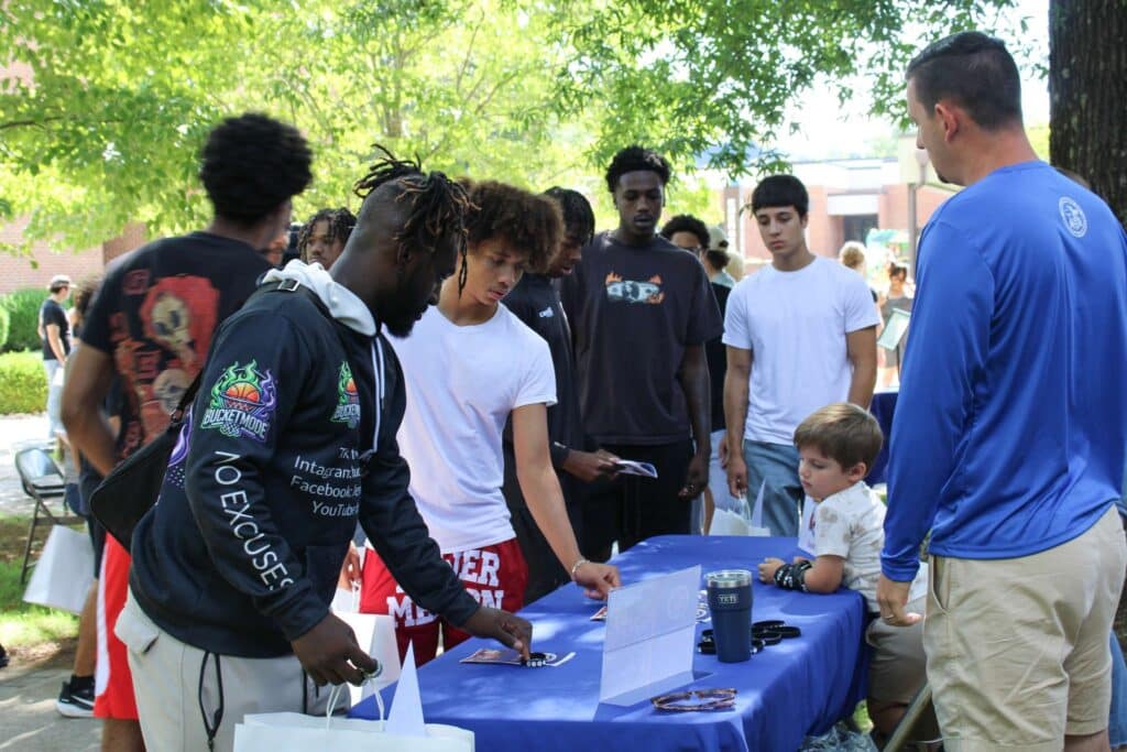 New students at an exhibit table on P&HCC Welcome Day