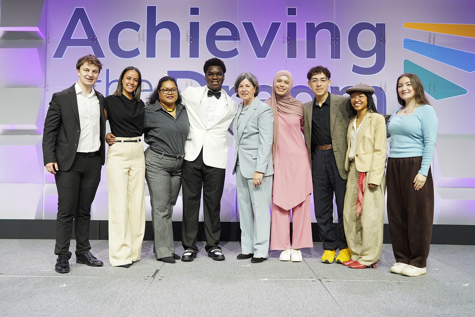 The 2026 DREAM Scholars and Karen Stout stand together on the DREAM 2026 stage